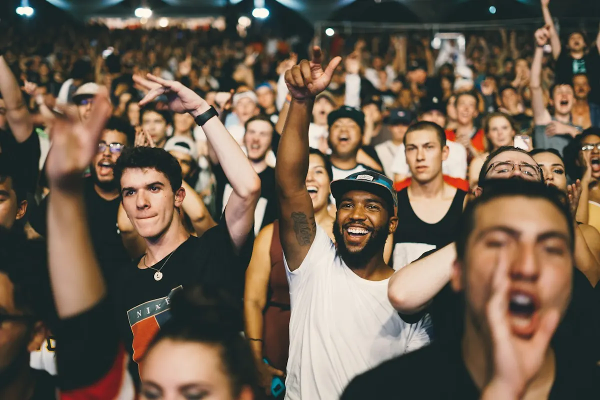 Multidão empolgada gritando em um evento, emoção de alta ativação que alimenta o marketing viral.